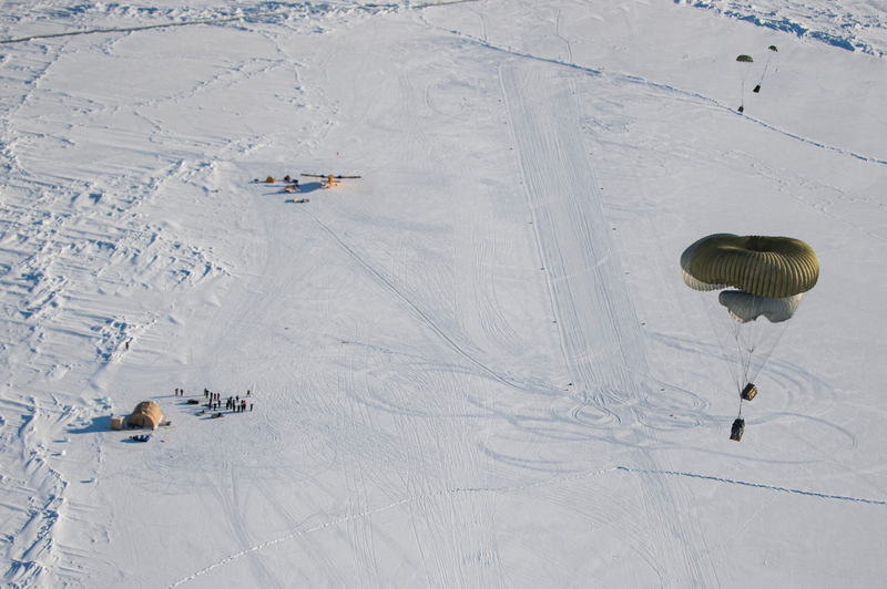Illustration for article titled Check Out These Shots Of A C-17 Dropping Pararescuemen Over The Navy's Arctic OutpostÂ